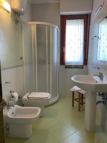 a bathroom with a shower and a toilet and a sink at Guest House 36 private parking in Orbetello