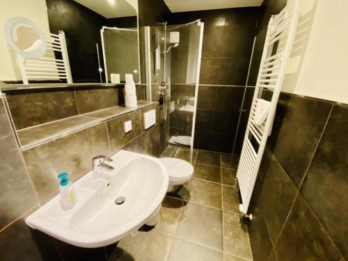 a bathroom with a sink and a toilet at Ferienhaus Viewpoint in Warnemünde