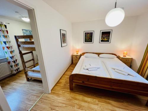 a small bedroom with a bed and a chair at Ferienhaus Streuwiese in Warnemünde