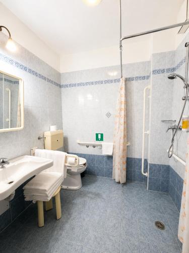 a bathroom with a sink and a toilet and a shower at Hotel Parigi 2 & Spa in Dalmine