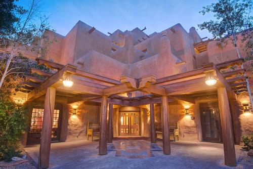 an exterior view of a house with a wooden structure at Inn & Spa at Loretto in Santa Fe