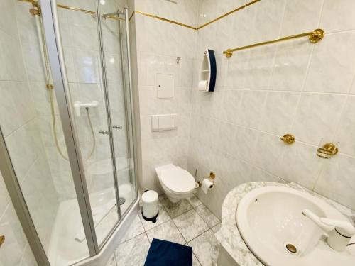 a bathroom with a shower and a sink and a toilet at Ostseeliebe, direkt an der Promenade in Warnemünde