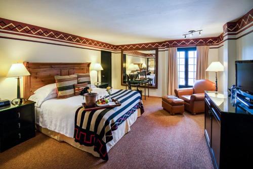 a hotel room with a bed and a television at Inn & Spa at Loretto in Santa Fe