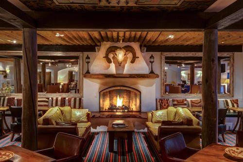 a living room with a fireplace with couches at Inn & Spa at Loretto in Santa Fe