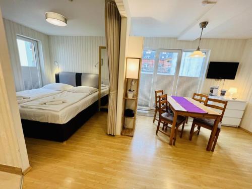 a bedroom with a bed and a table and chairs at Haus Juliane, Lichtblick in Warnemünde