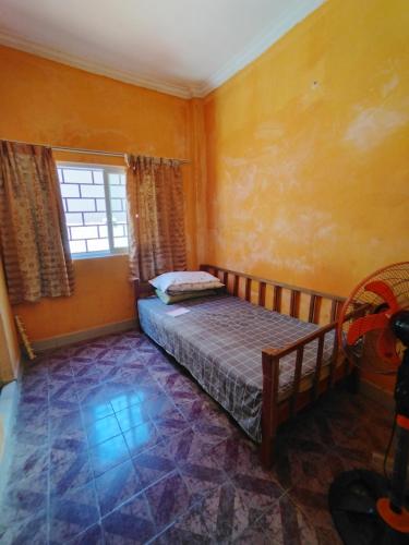 a bedroom with a bed and a window at Monica's house in Phnom Penh