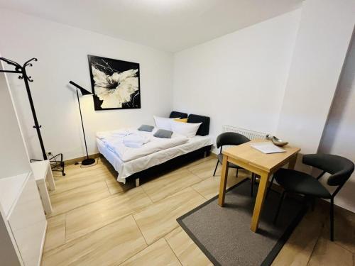 a living room with a bed and a table and chairs at Haus Juliane, Sandstrand in Warnemünde