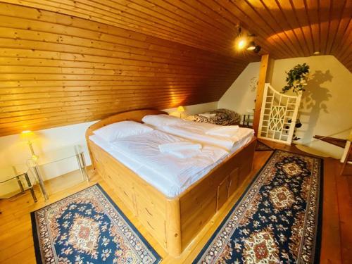 a bedroom with a bed in a wooden room at Ferienhaus Segelboot in Warnemünde