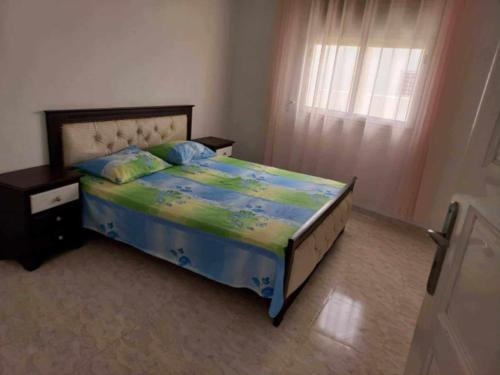 a bedroom with a bed and a window at Dar chat in Kelibia