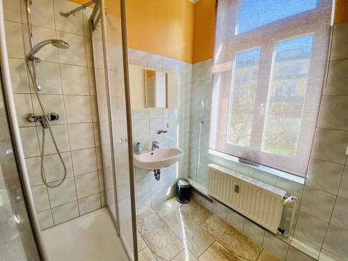a bathroom with a sink and a shower at Haus Juliane, Strandidyll in Warnemünde