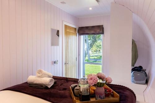 a room with a bed with a tray of food at Hare Hill - Dog Friendly in Penicuik