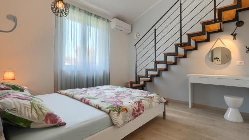 a bedroom with a bed and a staircase at Villa MA by Villas Guide in Vodnjan