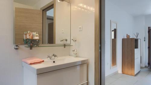 a white bathroom with a sink and a mirror at Villa MA by Villas Guide in Vodnjan