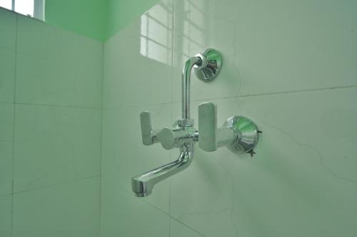 a shower with a faucet in a bathroom at Kaizen Stay-Inn in Jowai