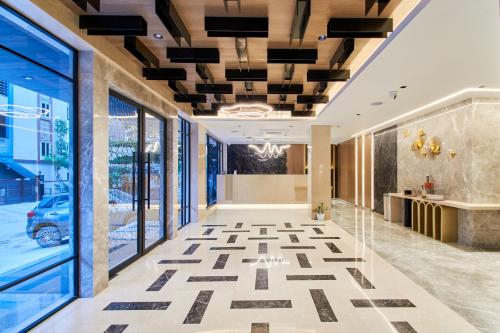 a lobby of a building with a tile floor at Hotel V Kondapur in Hyderabad