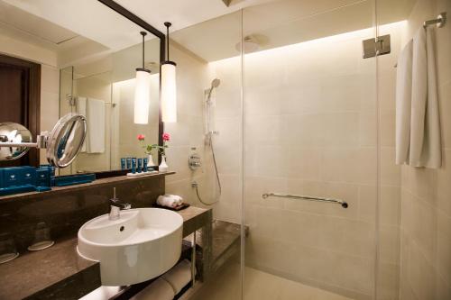 a bathroom with a sink and a shower at PARKROYAL Yangon in Yangon