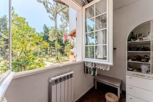 a kitchen with a window and a radiator at Dunevoile chambre d'hôtes in Biscarrosse-Plage