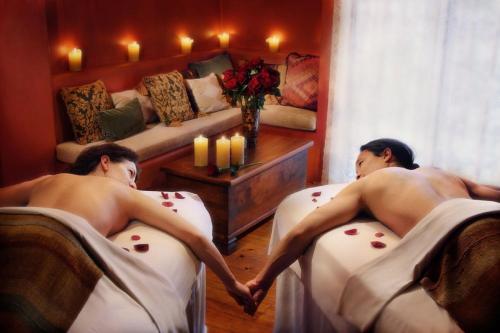 two naked men sitting in beds in a room at Inn & Spa at Loretto in Santa Fe