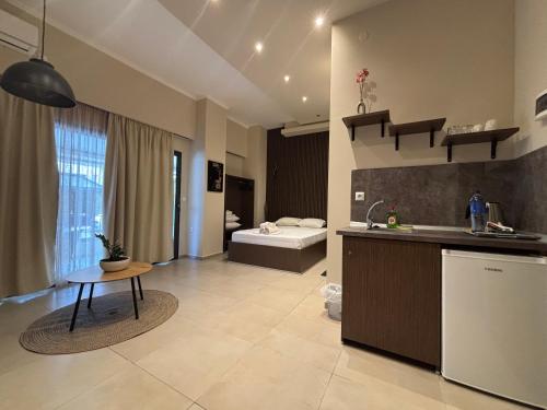 a kitchen with a sink and a table in a room at Hotel Epavli in Nea Kallikrateia