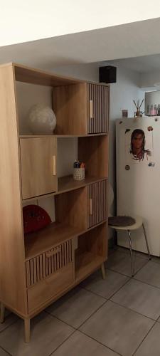 a wooden book shelf in a room at maison de village in Thuir