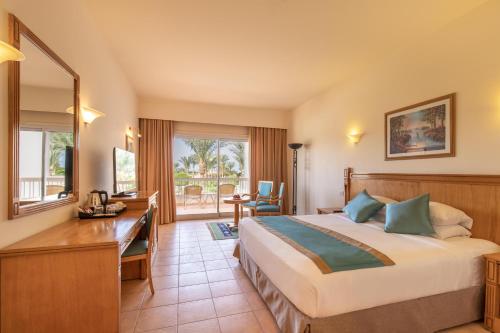 a hotel room with a bed and a desk at Hurghada Long Beach Resort in Hurghada