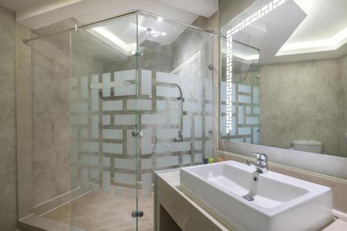 a bathroom with a sink and a glass shower at Hurghada Long Beach Resort in Hurghada