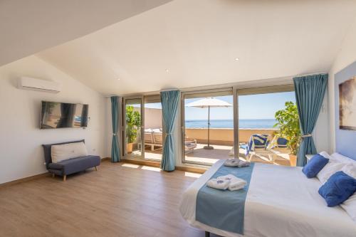 a bedroom with a bed and a view of the ocean at Suites At Sea II in Villajoyosa