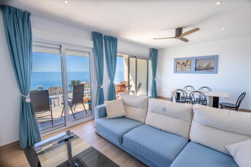 a living room with a couch and a view of the ocean at Suites At Sea II in Villajoyosa