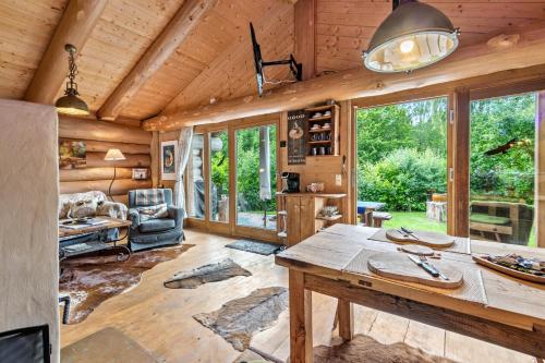 a log cabin living room with a large table at Ferienhütte 15 in Sankt Englmar
