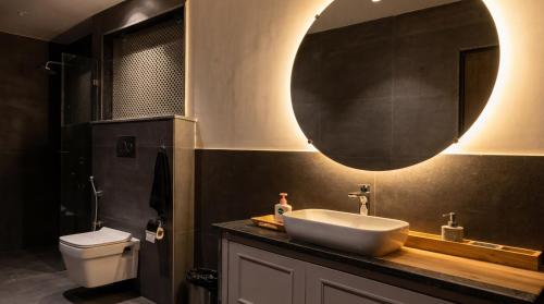 a bathroom with a sink and a mirror at Garrison at Dera Bagseu in Bikaner