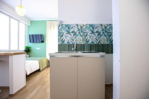 a bathroom with a sink and a bedroom with a bed at Pole Pole - NATURA in Agropoli