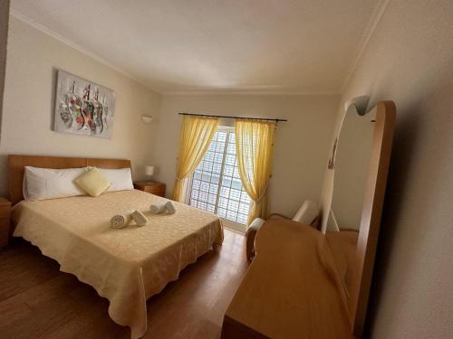 a bedroom with a bed and a window at Casa Loureiro - Vista Rio Douro in Resende