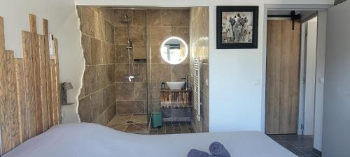 a bathroom with a shower and a bed in a room at Gîte la Cabridello in Barbentane