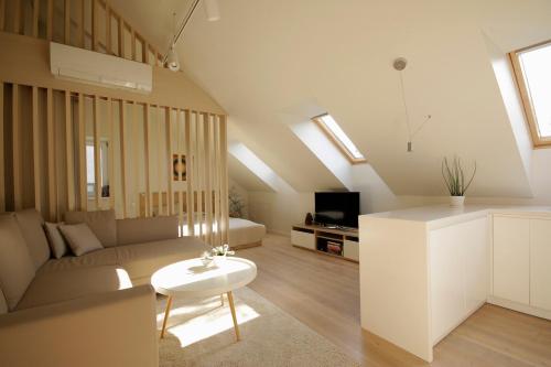 a living room with a couch and a table at Old Town Apartment with FREE Parking in Marijampolė