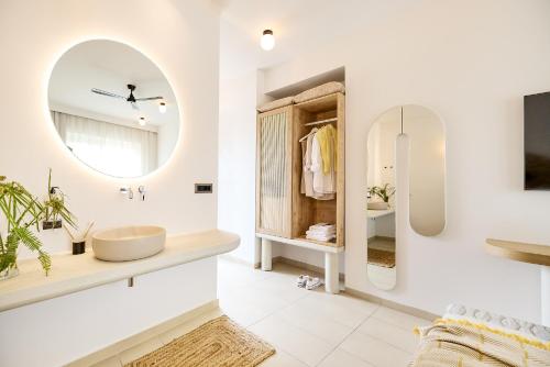 a bathroom with a sink and a mirror at Maravel Star Art Hotel in Adelianos Kampos