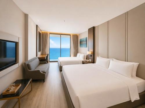 a hotel room with a large bed and a television at HD Panorma Nha Trang Free Pool & Gym Condotel in Nha Trang
