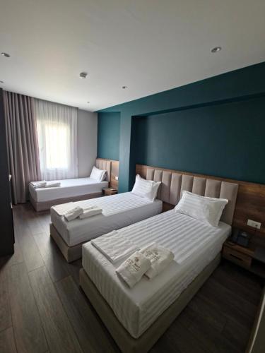 a hotel room with two beds and azeb sidx sidx sidx sidx sidx at HOTEL CENTERPOINT Tirana in Tirana