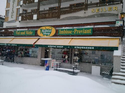 a store in the snow in front of a building at Modern ski-in Appartement 2020m Kühtai in Kühtai