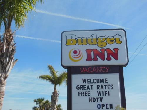 a sign for a burger inn with palm trees at Budget Inn - Saint Augustine in Saint Augustine