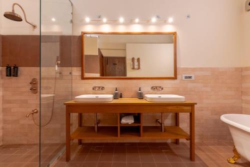 a bathroom with two sinks and a mirror at Over The World in Rāmgarh