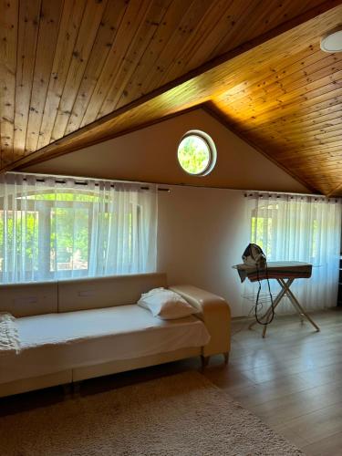a bedroom with a bed and a window and a table at Drini river view in Shkodër