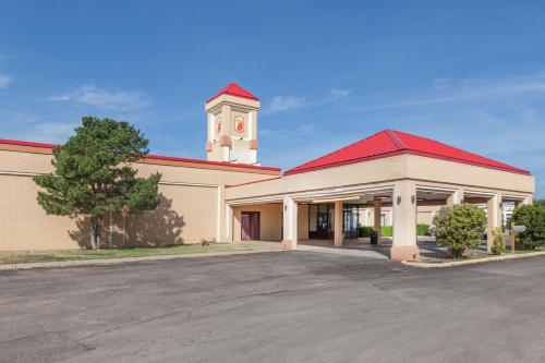 a building with a clock tower on top of it at Super 8 by Wyndham Plainview in Plainview