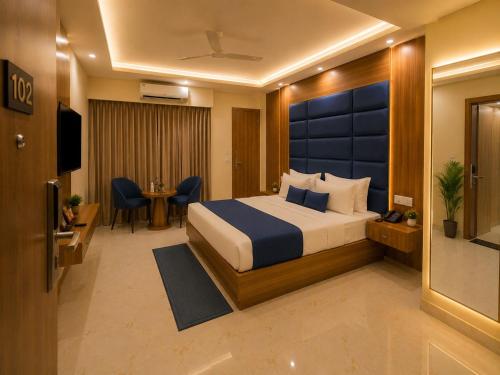 a hotel room with a bed and a television at Hotel Luxe Elite IGI Delhi in New Delhi
