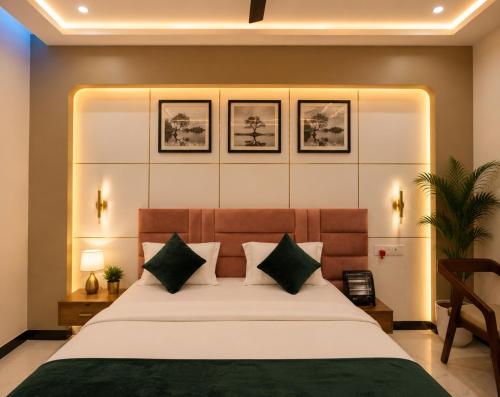 a bedroom with a large bed with two pillows at Royal Awadh Inn Near Shree Ram mandir in Ayodhya