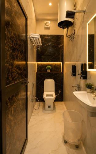 a bathroom with a toilet and a sink at Royal Awadh Inn Near Shree Ram mandir in Ayodhya