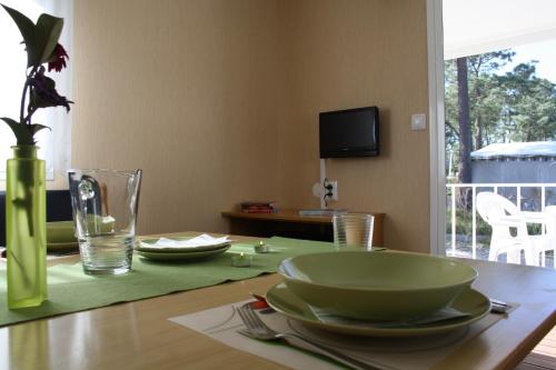 a wooden table with a bowl and plates on it at Valbom by Campigir in Sesimbra