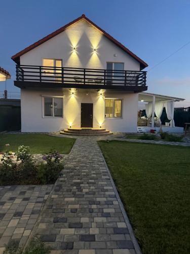 a white house with a walkway in front of it at Villa Menorca in Chornomorsk