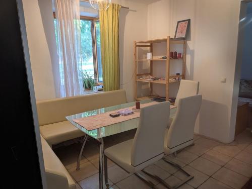 a dining room with a glass table and chairs at Appartement Julis 1 in 3430 Tulln in Tulln