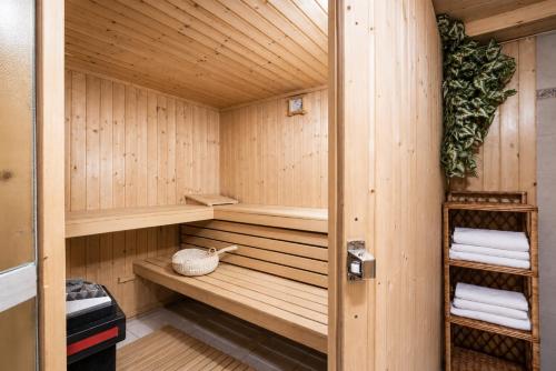 a sauna with wooden walls and wooden shelves at Apartments Ladka in Begunje na Gorenjskem