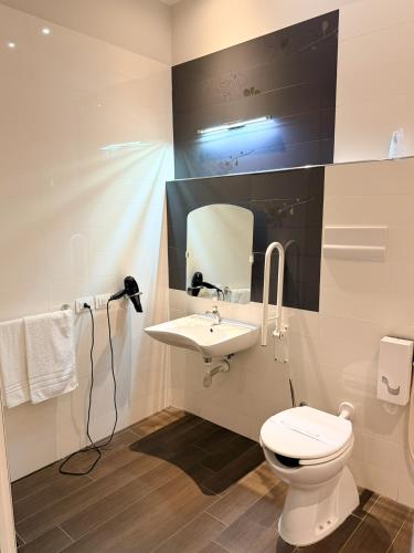 a bathroom with a white toilet and a sink at S Hotel in San Giovanni Teatino